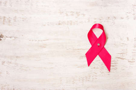 Pink ribbon on white background. International symbol of the fight against breast cancer, oncologyの写真素材