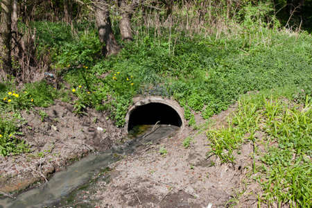 Wastewater pipe from which dirty water flows, sewerage. Pollution of ecology, natureの写真素材