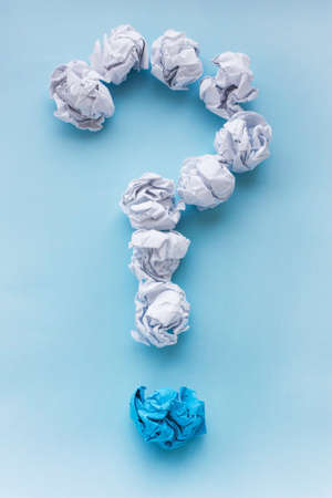 Question mark from crumpled white and blue paper balls. Concept ideas. View from above, flatの写真素材