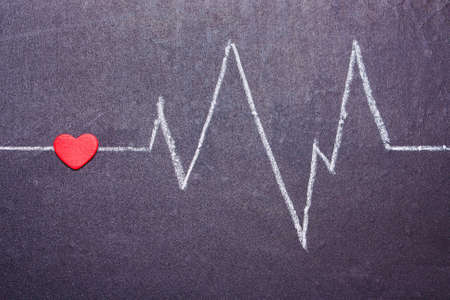 The cardiogram of the heart is painted with chalk on a blackboard. Concept of Love, Valentine's Day