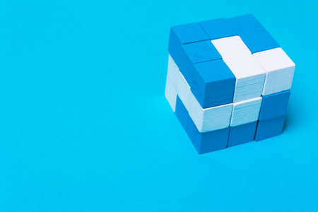 Geometric cube of blue and white parts. Concept of creativity, cohesion, unity, successful...