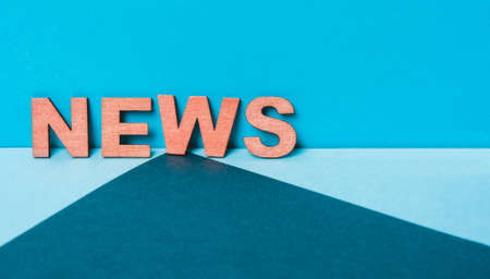 word News on a blue wooden letter background