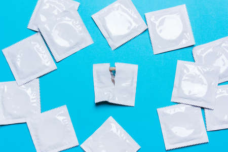 Condom on a blue background. The concept of safe sex, stop infection of sexually transmitted diseases,STD, AIDS.の写真素材