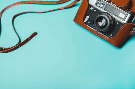 Vintage old photo camera on a blue background. Retro concept. View from above, flatの写真素材