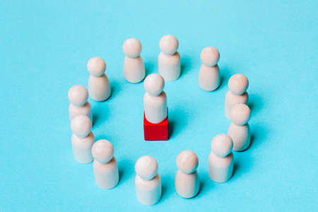 Wooden figures on a blue background. Leader and team. Business structure Management inside the organization.の写真素材