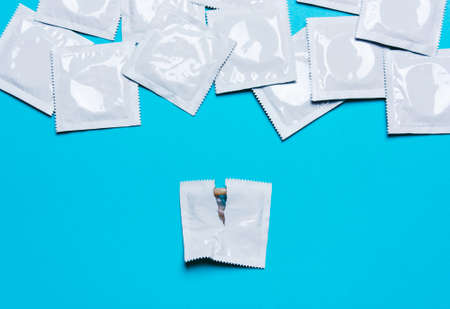 Condom on a blue background.The concept of safe sex; stop infection of sexually transmitted diseases; STD; AIDS.の写真素材