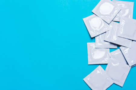 Condom on a blue background. Concept for reducing the likelihood of pregnancy, safe sex