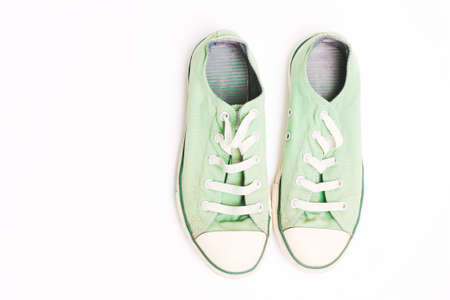 Old green sneakers, shoes. Concept of multiple trips, free life, tourism