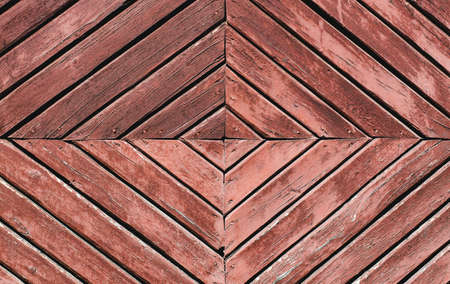Red, old wooden doors with peeling paint, abstract background of planksの写真素材