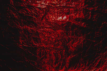 Dark red  Halloween hellish grunge abstract crumpled aluminum, titanium shiny foil background