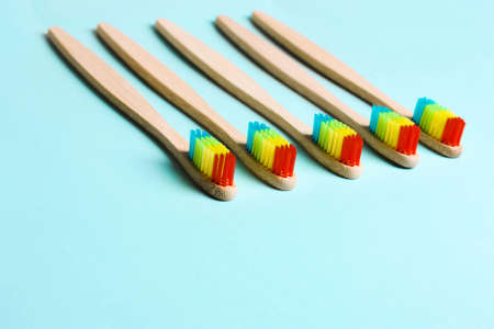 Eco bamboo toothbrush, organic on a blue background of colored bristles.  view i flat, from above. Concept of protection of nature, the environment.
Eco friendlyの写真素材