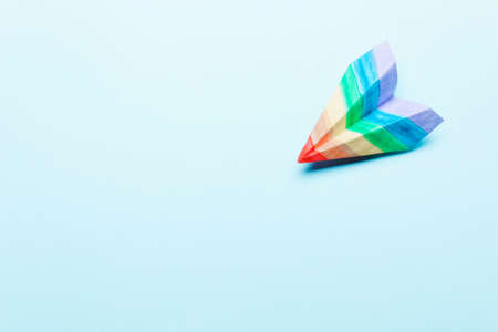 Lgbt flag. Paper plane colors of the rainbow on a blue backgroundの写真素材