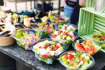 Vegetarian appetizing salads, mussels at a street festivalの写真素材