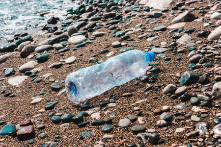 Used plastic bottle in water. Concept of pollution of the environment, ocean, sea, nature. Save the planet..zero wasteの写真素材