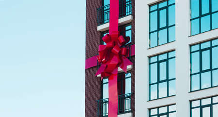 The concept of buying an apartment, buy, get it, on credit. A house with a bow, a gift