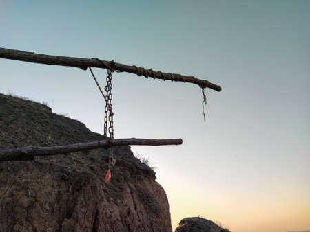 Handmade barrier with a chain on sky the backgroundの写真素材