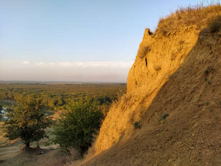 Sunset valley wirh hills and trees and the river below