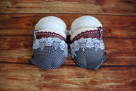 Set of different women's bra on wooden background. Underwear fashion concept with a copyspaceの写真素材