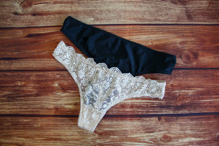 Woman lace sexy panties on the wooden background with copyspace