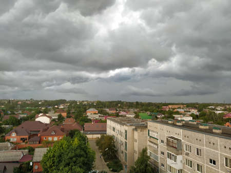 Dark storm clouds over the cityの写真素材