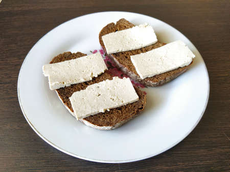 Two black bread sandwiches with tofu cheeseの写真素材