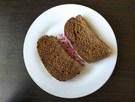 Two pieces of black bread on a plateの写真素材