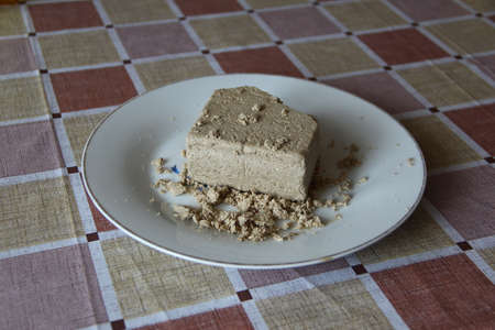 Piece of delicious sunflower halva on a white plateの写真素材