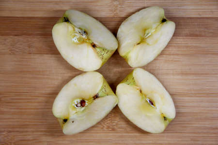 Four pieces of apple on the wooden backgroundの写真素材