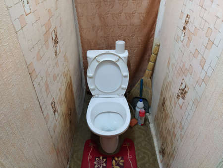 Old toilet room with a poor renovationの写真素材