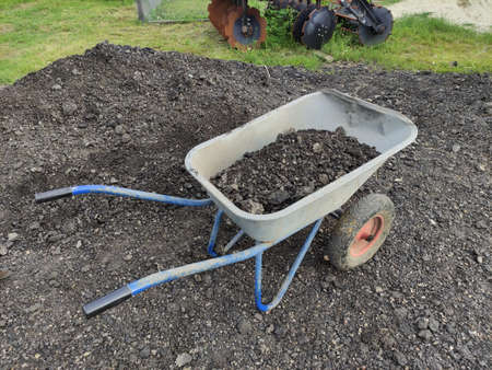 Wheelbarrow with stones, coal or fertilizer and manureの写真素材