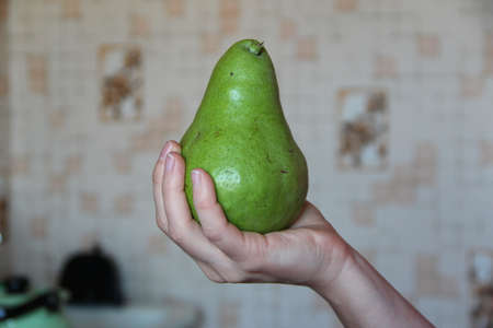 Woman's hand holds the large green pearの写真素材