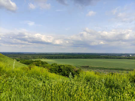 Landscape - valley, fields, forest and sky in a cloudsの写真素材