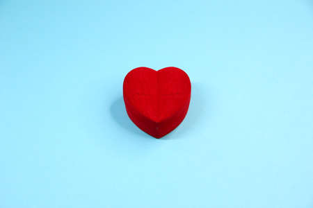 Red velvet box in the form of a heart on the blue background, copy spaceの写真素材