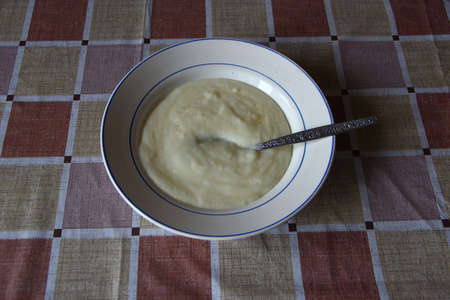 Plate of the semolina porrige on the table
