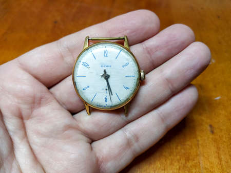 Old soviet gold wrist watch in the hand close-upの写真素材