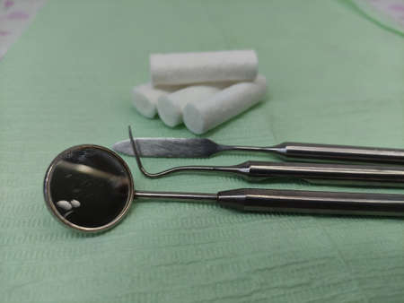 Dental instruments and swabs on the napkin, close-up
