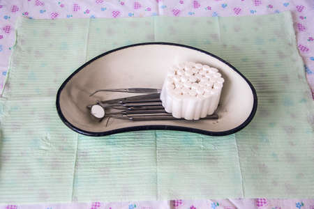 Dental instruments and cotton swabs in the trayの写真素材