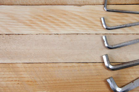 Set of hex keys on the wooden background with a copy space