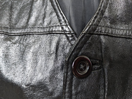 Plastic button on the leather vestの写真素材