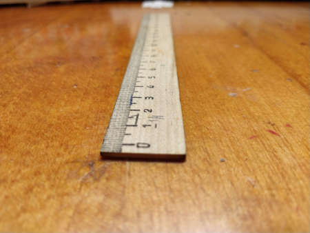 Wooden ruler on the table, close-upの写真素材