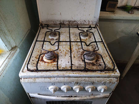 Very dirty and old gas stove in a kitchenの写真素材