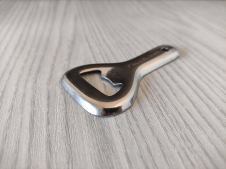 Metal bottle opener on the tableの写真素材