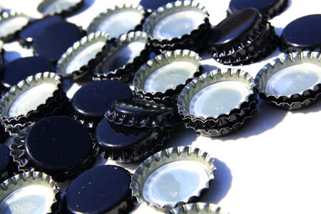 Black beer caps isolated on white background