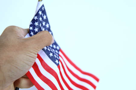 hand holding a us flag. american and proud concept