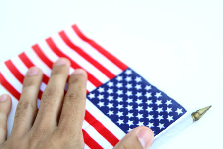 hand over a us flag. isolated over a white backgroundの写真素材