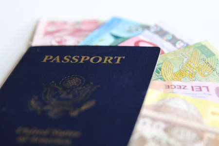 USA passport and international currencies on a white backgroundの写真素材