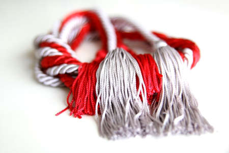 grey and red ropes with tassel isolated on white