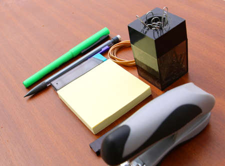 office desk and tools over a brown table backgroundの写真素材