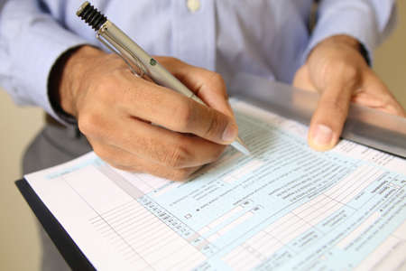 Businessman at office desk signing a contract. signatureの写真素材