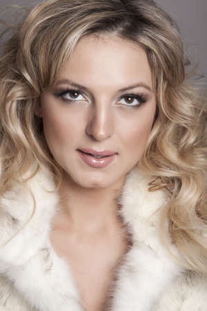 Portrait of beautiful blonde woman on grey background の写真素材